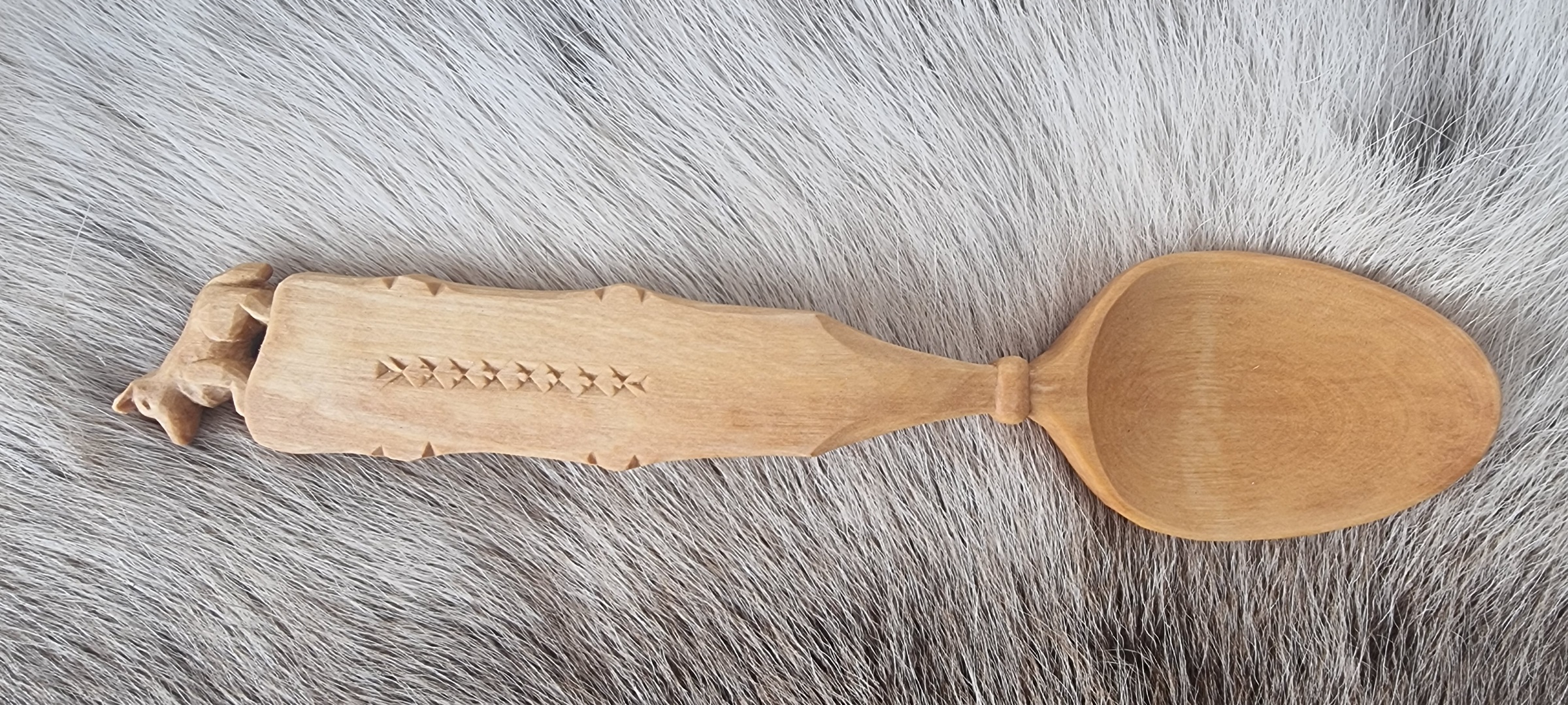 Berkenhouten lepel op een rendiervel